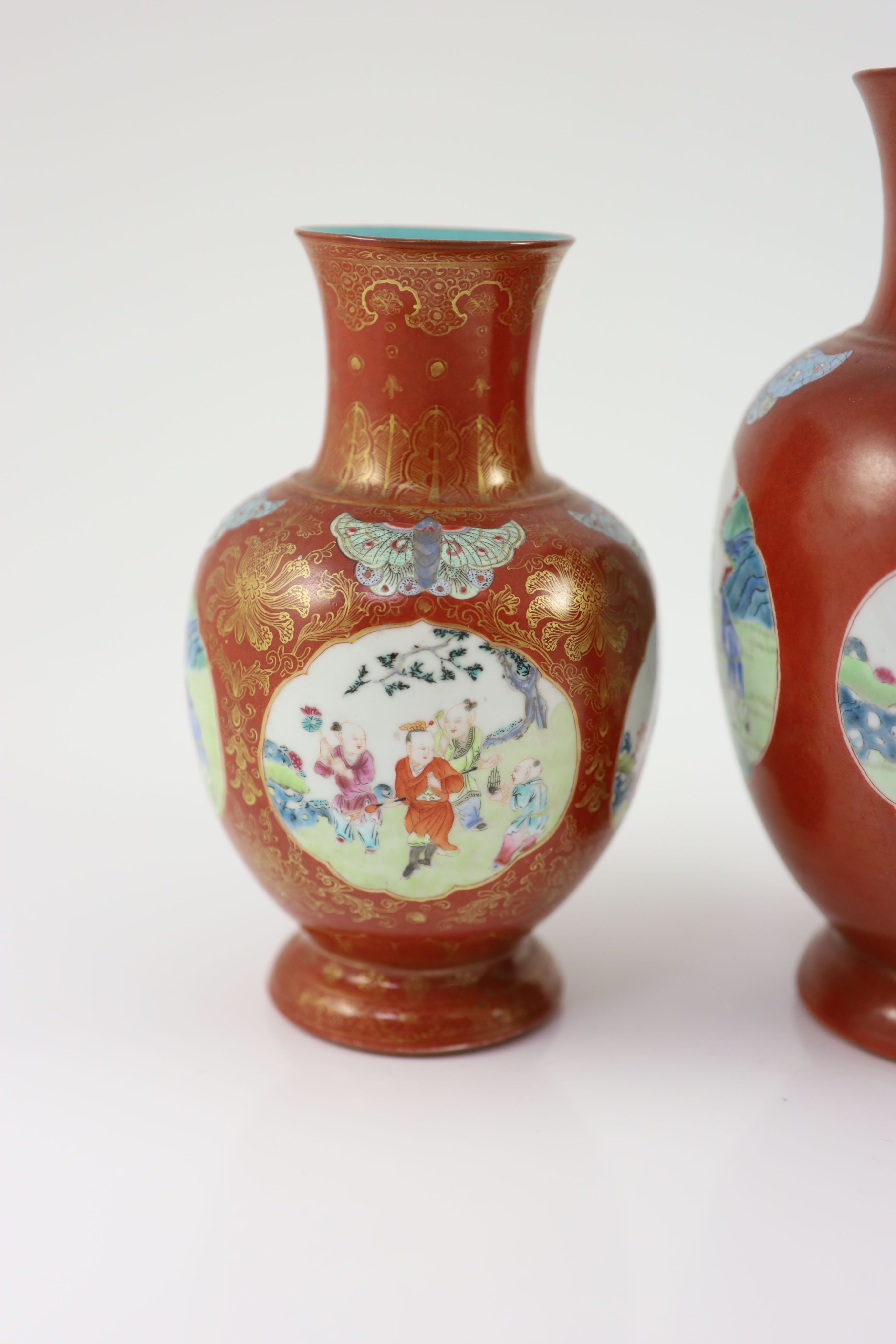 A set of three Chinese coral ground ‘boys’ vases, Jiaqing period (1796-1820), 19.5 and 23.5cm high